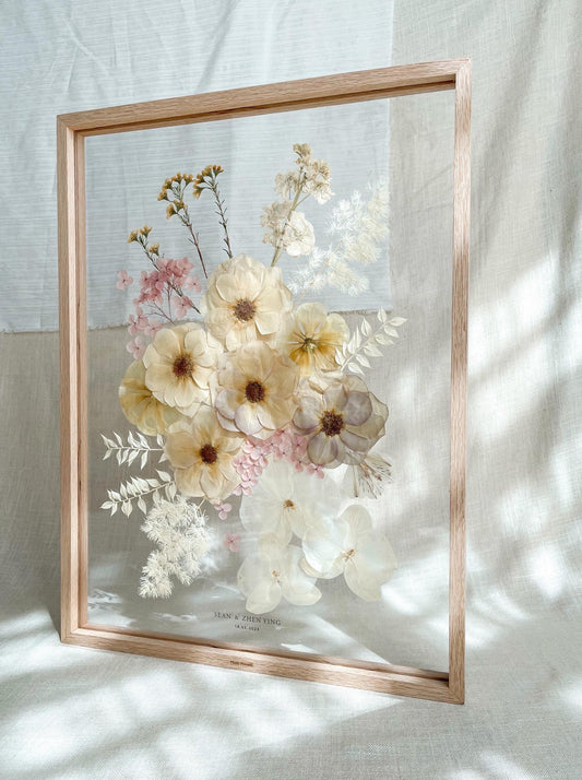 A2-sized Pressed Flower Frame with pink, white and orange flowers, framed with natural wood